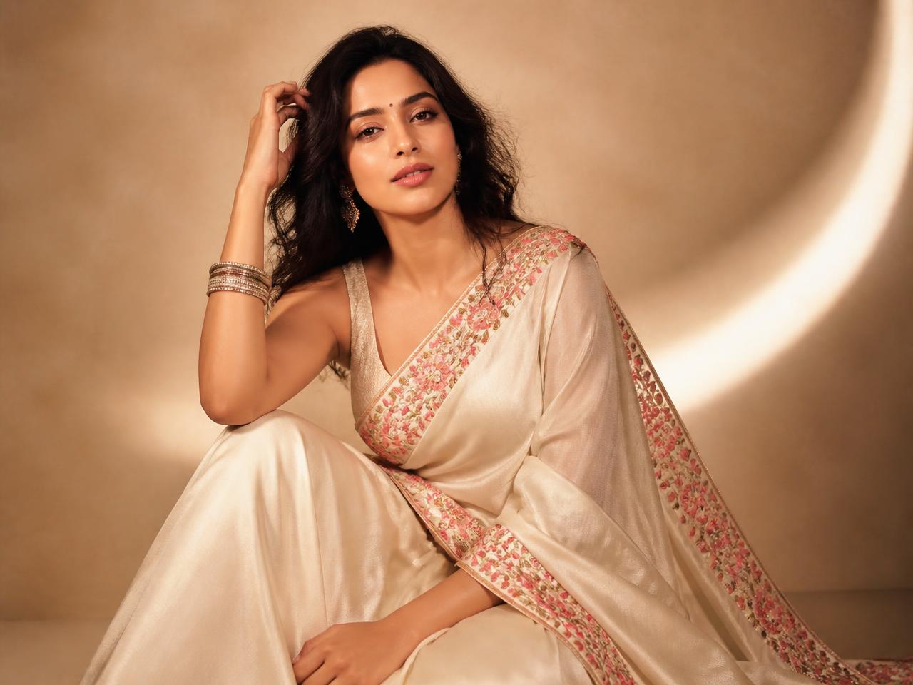 Model in an ivory floral-border silk saree